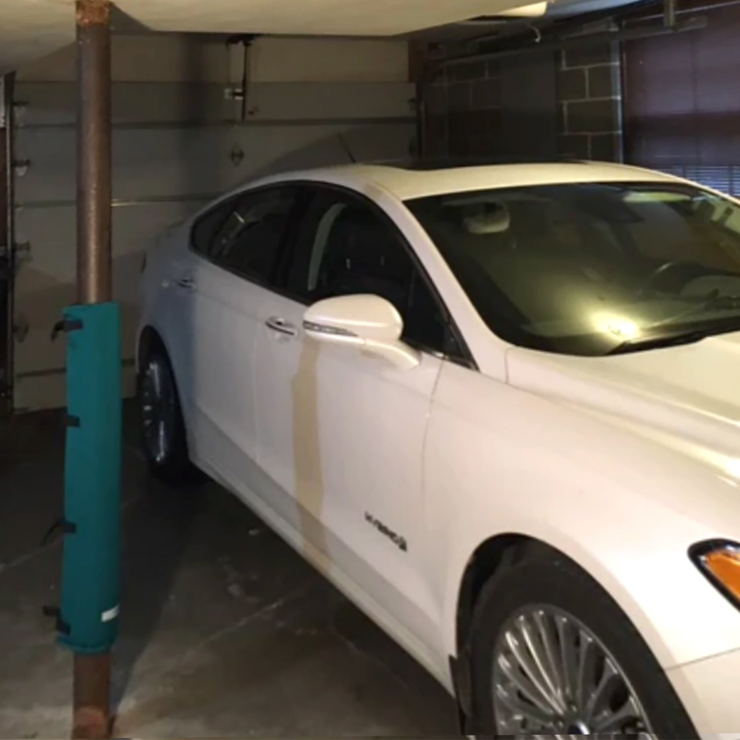 Green Padding for garage poles. Garage pole pad that secures to your garage pole to prevent dings and dents on your car door.